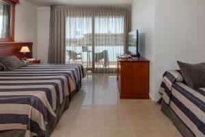 Posteľ alebo postele v izbe v ubytovaní Hotel Panorama