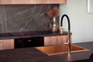 a kitchen counter with a sink in a kitchen at Apartament Glamour in Kwidzyn