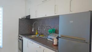 a kitchen counter with a sink and a dishwasher at Twins Land in Mostar