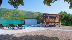 a gazebo and chairs next to a pool at Twins Land in Mostar