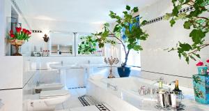 a white bathroom with two sinks and a toilet at Breitner House in Amsterdam