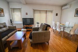 a living room with a couch and a table at VN APARTMENTS OHRID in Ohrid