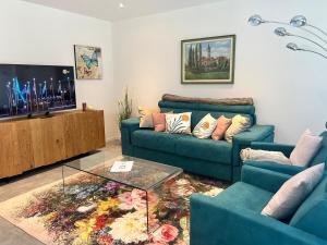 a living room with two blue couches and a coffee table at LabPark luxury Melano in Melano