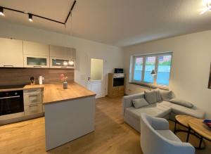 a kitchen and living room with a couch and a table at 6010 Hollige 20 in Walsrode
