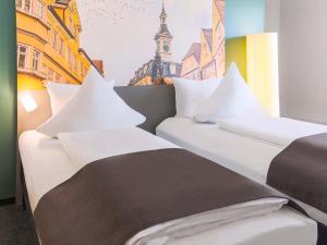 Postel nebo postele na pokoji v ubytování B&B Hotel Aalen + 7 fotografií