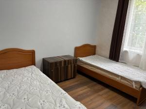 a bedroom with two beds and a window at DS Appartment in Yerevan in Yerevan
