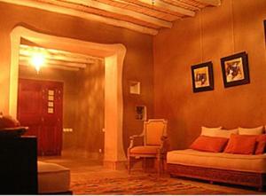 a bedroom with a bed and a chair in a room at Dar Al Manar in El Jadida