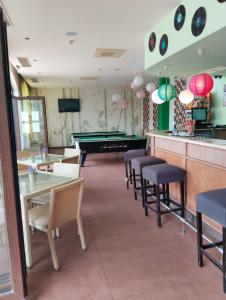 a restaurant with tables and chairs and a pool table at 2 Room Apartment with Poolview Royal Sun in Sunny Beach