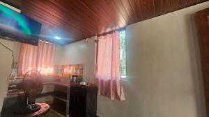 a living room with a television and a window at Bhatye Beach Resort Rejunuvation in Ratnagiri