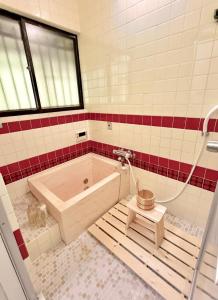 a bathroom with a tub and a toilet in it at ぽんぽこハウス in Tokoname +20 photos
