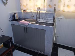 a kitchen counter with a sink and a sink at Leilani Homes in Kajiado