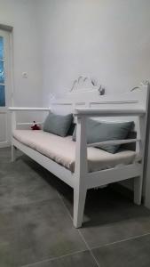a white bed with pillows on it in a room at Elysium Sifnos in Artemonas
