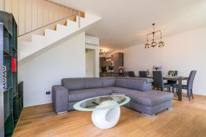 a living room with a couch and a table at Spa Stella Lario in Lezzeno +35 photos