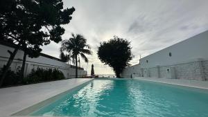 a swimming pool with blue water next to a building at Hi Yang Seaview Villa in North Pattaya