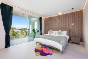 a bedroom with a large bed and a balcony at Hi Yang Seaview Villa in North Pattaya