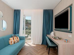 TV a/nebo společenská místnost v ubytování Hotel Tirrenia