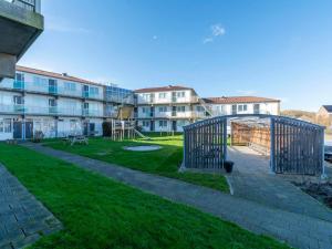a park with a playground in front of some buildings at Beach Apartment 7 for 4 guests in Callanstoog in Callantsoog