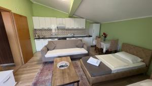 a living room with a couch and a table at Prizren Apartment's in Prizren