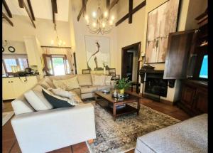 a living room with a couch and a coffee table at Aviemore Lodge in Dullstroom