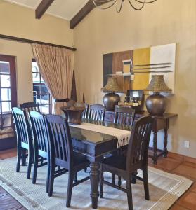 a dining room with a table and chairs at Aviemore Lodge in Dullstroom