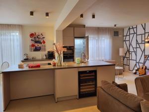 a kitchen with an island in the middle of a living room at B&B Ut Zuuje in Valkenburg