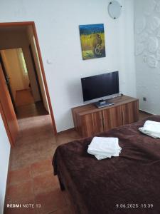 a room with two beds and a flat screen tv at Apartament z dwiema sypialniami i aneksem kuchennym in Karpacz