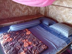 a bed in the back of a tent at Blue Moon Bungalow in Ko Bu Bu