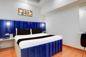 a blue and white bedroom with a large bed at Prince Lodge and Banquet in Khairāni