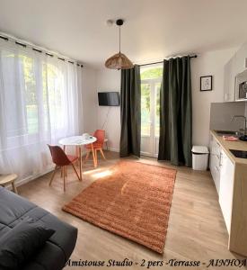 a living room with a couch and a table at Les Pastourelles in Capbreton