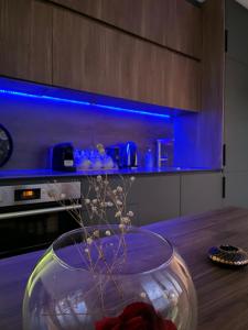 a vase with flowers in it on a table in a kitchen at Nick Apartment in Pristina +3 photos