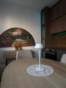 a table with a lamp on top of it in a kitchen at Nick Apartment in Pristina