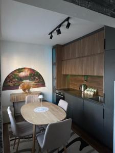 a kitchen with a table and chairs in a room at Nick Apartment in Pristina