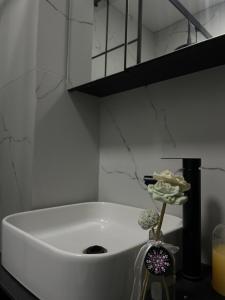 a white bath tub in a bathroom with a candle at Nick Apartment in Pristina