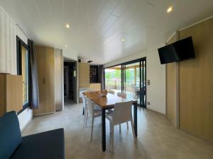 a kitchen and dining room with a table and chairs at Grand chalet familial in Figeac