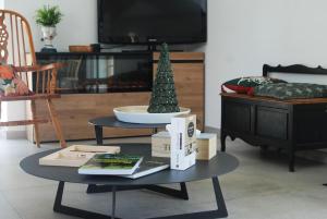 a living room with a table with a christmas tree on it at La hal'te verte in Rilly-sur-Aisne