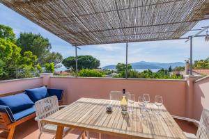 a table with wine glasses on a balcony with a view at Villa del sole 4 in Capoliveri