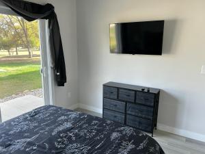 a bedroom with a bed and a tv on a wall at The Hygge House in Spirit Lake