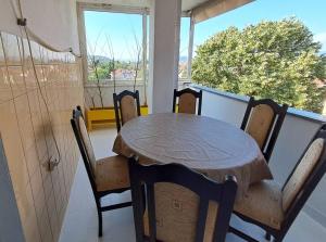 a table and chairs in a room with a window at DIANANINA the Flat in Gevgelija