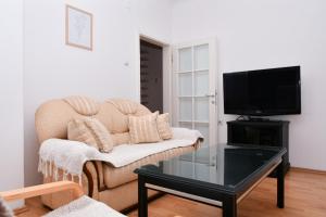 a living room with a couch and a tv at DIANANINA the Flat in Gevgelija