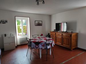 ThéniouxにあるAuthentique maison éclusièreのダイニングルーム(テーブル、テレビ、窓付)
