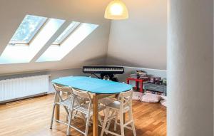 a table and chairs in a room with skylights at Five Bedroom Cozy Home In Jerzykowo 