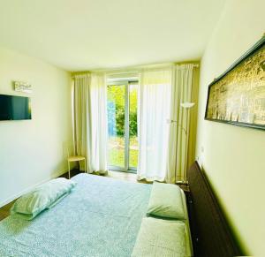 a bedroom with a large bed and a window at Dock House in Marone