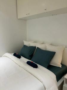 a large white bed with green and white pillows at Comfortable Apartment in Brussels, 35 m², 3 Persons in Brussels