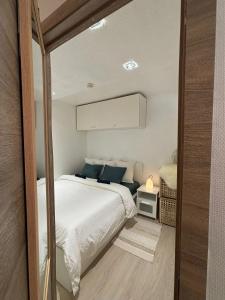 a bedroom with a large white bed with blue pillows at Comfortable Apartment in Brussels, 35 m², 3 Persons in Brussels +7 photos