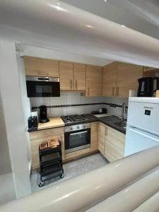 a kitchen with wooden cabinets and a stove top oven at Comfortable Apartment in Brussels, 35 m², 3 Persons in Brussels +7 photos