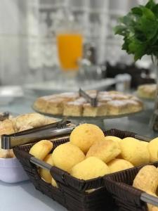 two baskets of bread and pies on a table at Hotel El Shaday in Nazário