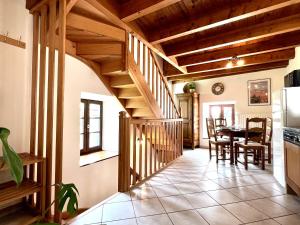 a kitchen and dining room with a staircase in a house at Gîte Le Nid d'Ange in Saint-Privat-dʼAllier