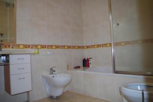 a bathroom with a sink and a toilet and a shower at BellaVita City Faro in Faro +47 photos