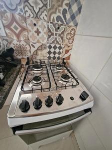 a white stove top oven sitting in a kitchen at Vista mar e mata atlântica Casa Completa Ilhéus WI-FI 800m in Ilhéus