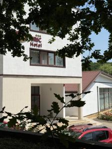 a building with a car parked in front of it at Hotel Ciric in Iaşi